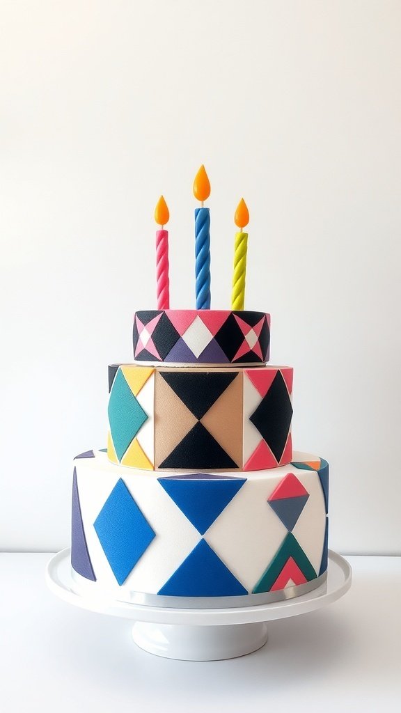 A three-tiered birthday cake with bold geometric designs in various colors and shapes, topped with colorful candles.