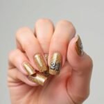 Gold glitter 21st birthday nails with accent number design