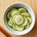 Japanese cucumber salad served in a small ceramic bowl with sesame seeds sprinkled on top