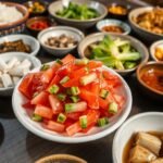 Traditional Korean table setting with various banchan dishes including korean cucumber salad