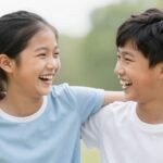 A brother and sister laughing together outdoors, capturing their special sibling bond on his happy birthday