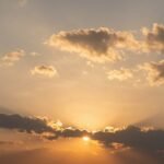 A serene sunset with rays of light breaking through clouds, symbolizing a happy birthday in heaven celebration