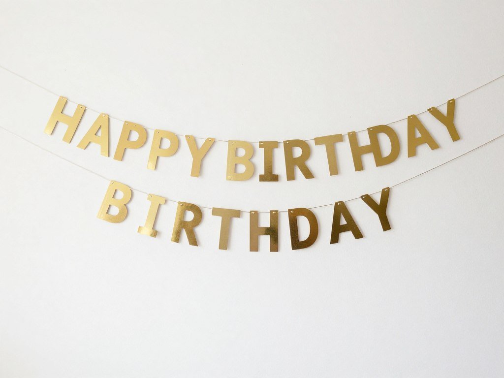 Happy birthday banner displayed against a clean white wall as perfect backdrop Happy birthday banner displayed against a clean white wall as perfect backdrop