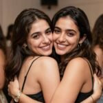 Two female cousins embracing and smiling on a happy birthday celebration