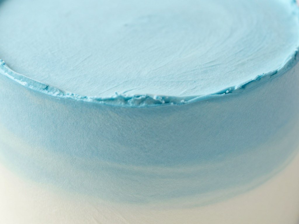 close up view of blue gradient Korean cake with smooth frosting texture close up view of blue gradient Korean cake with smooth frosting texture