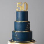 elegant 50th birthday cake for men with gold accents and number fifty topper