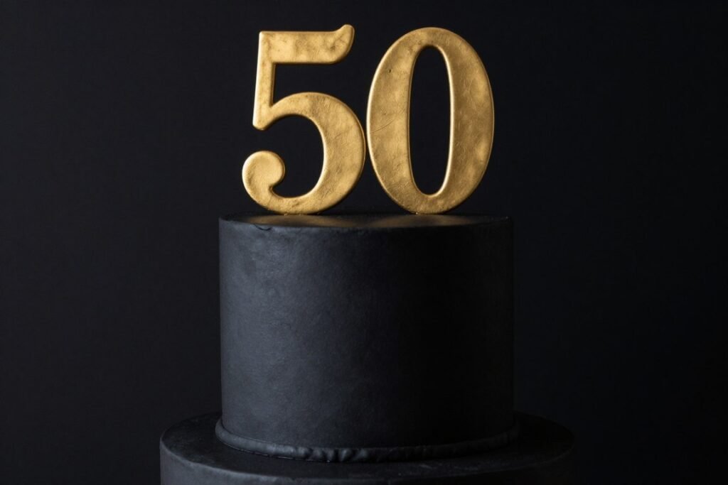 minimalist black cake with gold number fifty topper for men
