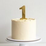 simple 1st birthday cake designs with minimal frosting and pastel decorations